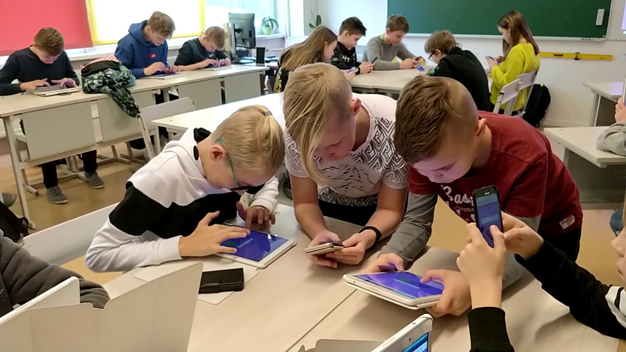 Children playing 99math games on tablets