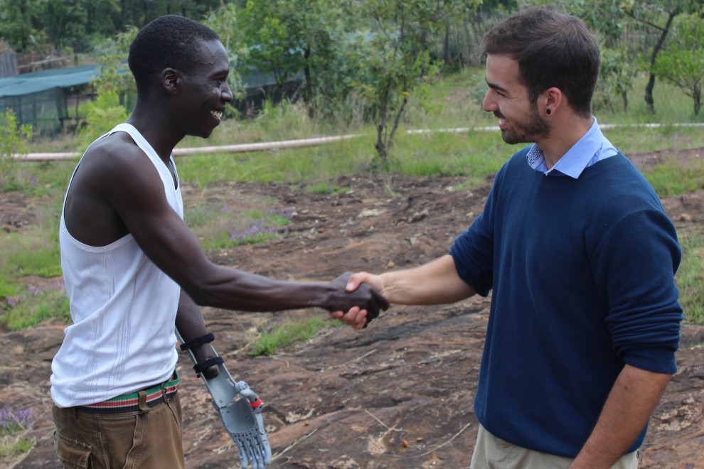 Guillermo Martinez of Ayudame shaking hands with 3D-printed limb recipient