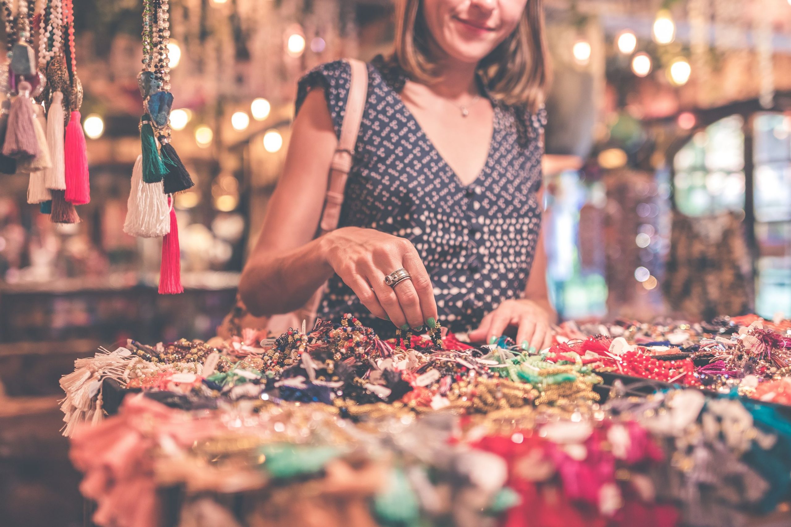 Woman looking at jewellery -- Shop by Shopify