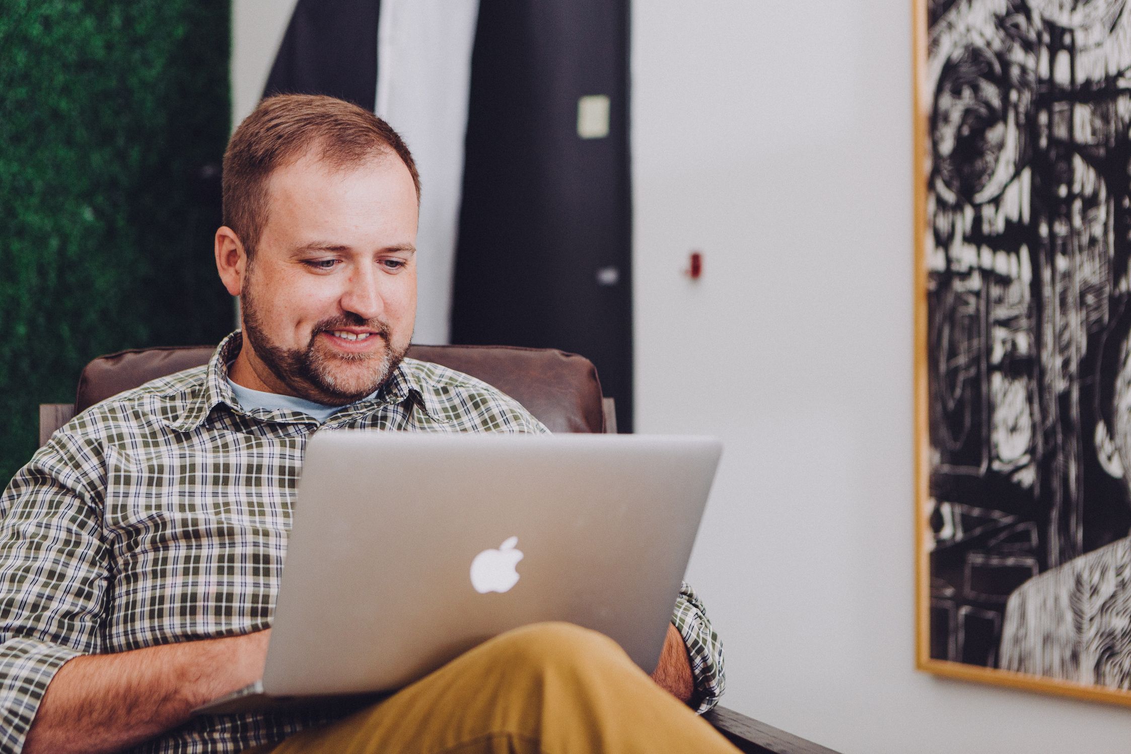 Smiling man on laptop -- SilverCloud Health