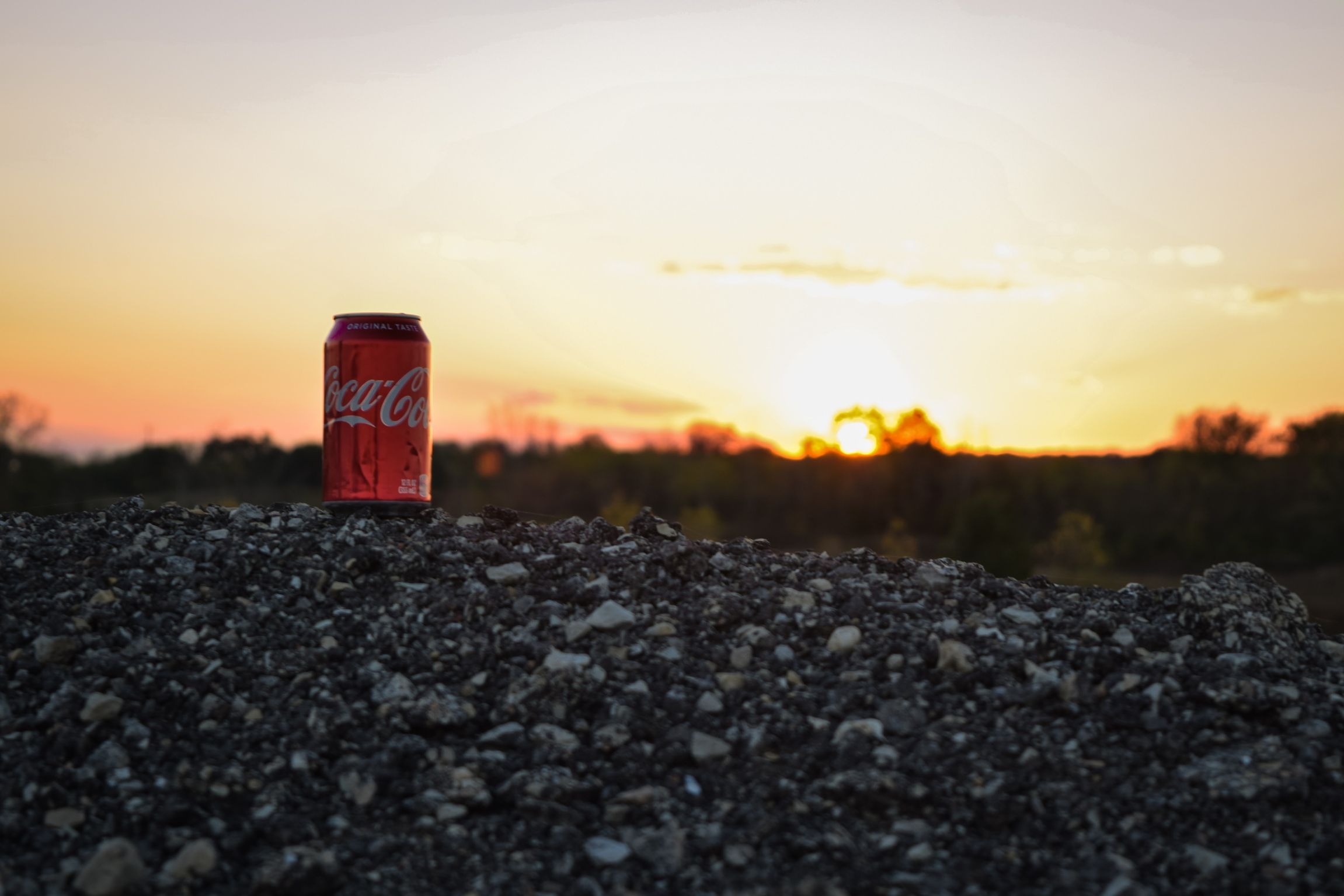 Coke can with sunset in the background -- Azelio