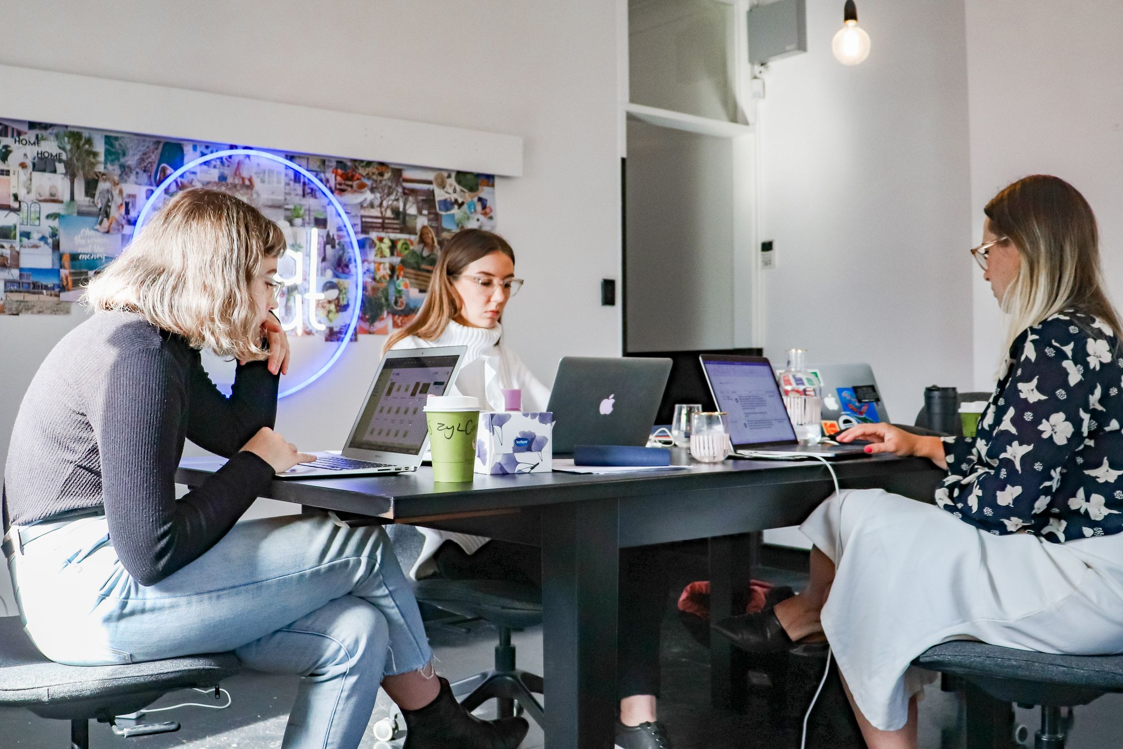 three women working on laptops